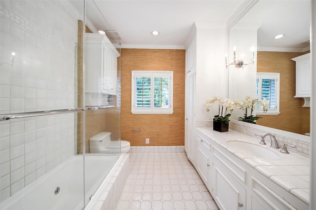 bathroom with toilet, vanity, ornamental molding, and wooden walls