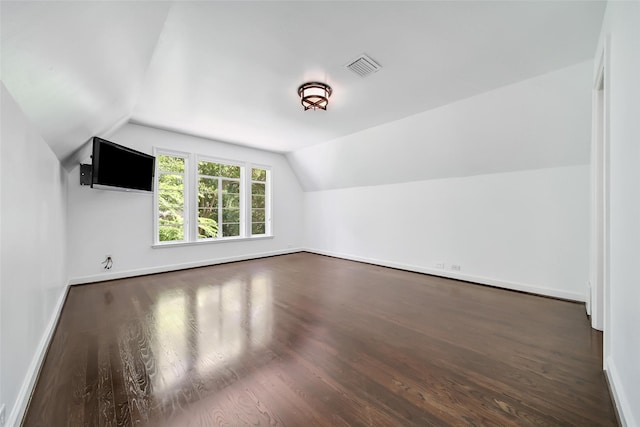 bonus room with dark hardwood / wood-style flooring and lofted ceiling