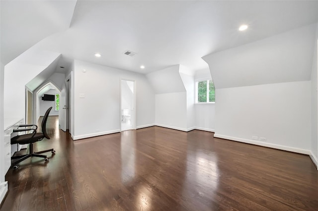 home office featuring vaulted ceiling and dark hardwood / wood-style flooring