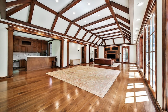 interior space featuring lofted ceiling with beams and ornate columns