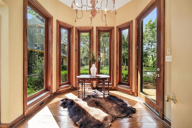 sunroom featuring an inviting chandelier