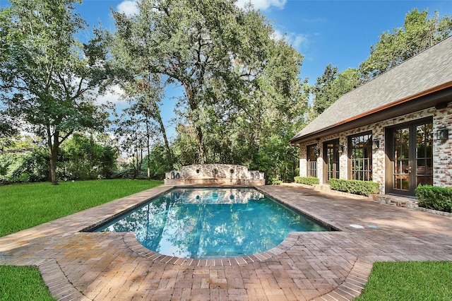 view of pool featuring a yard and a patio