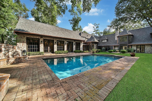 view of swimming pool with a patio area and a lawn