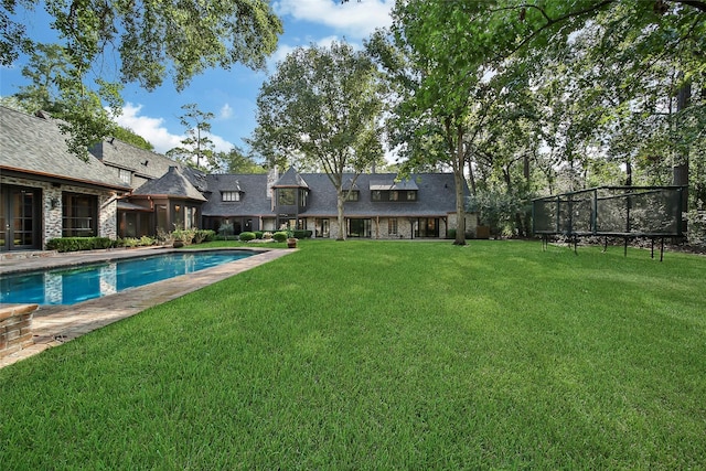 exterior space with a yard and a trampoline