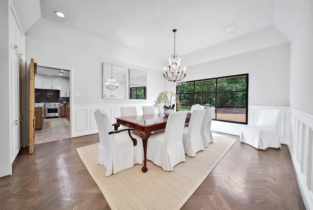 dining room featuring dark parquet flooring and a chandelier