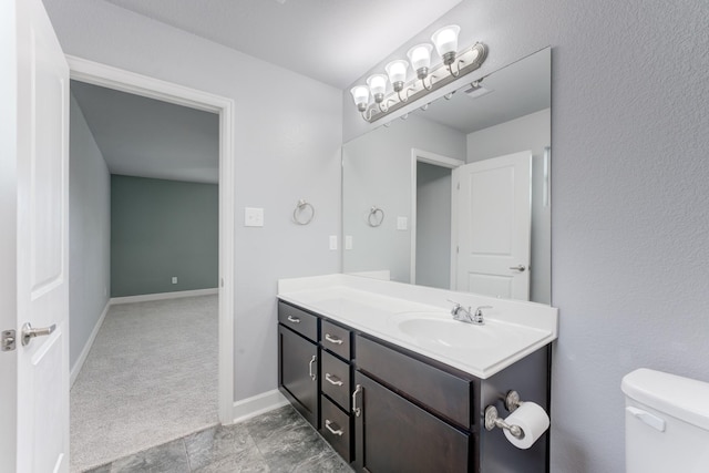 bathroom featuring toilet and vanity