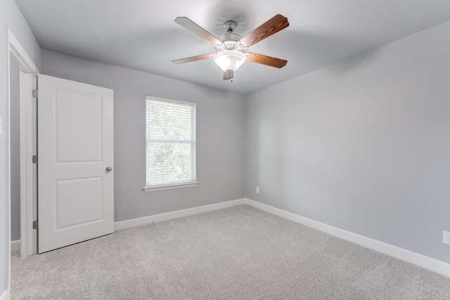 unfurnished room featuring ceiling fan and light colored carpet