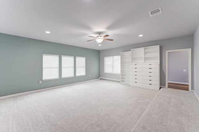 unfurnished bedroom featuring ceiling fan and light colored carpet