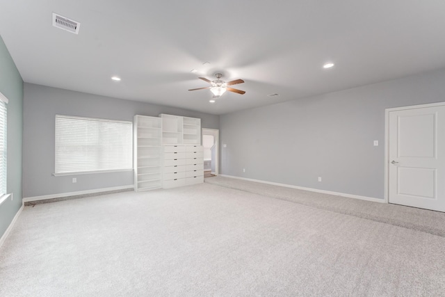 unfurnished bedroom with ceiling fan and light carpet