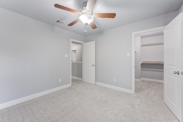 unfurnished bedroom with light carpet, ceiling fan, and a closet