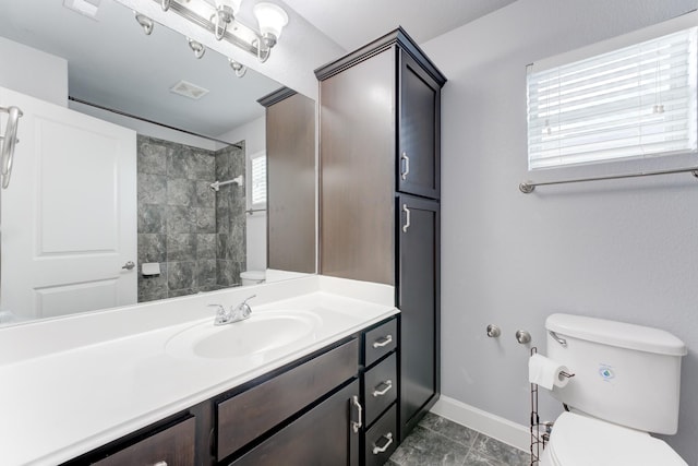 bathroom featuring toilet, vanity, and tile patterned floors