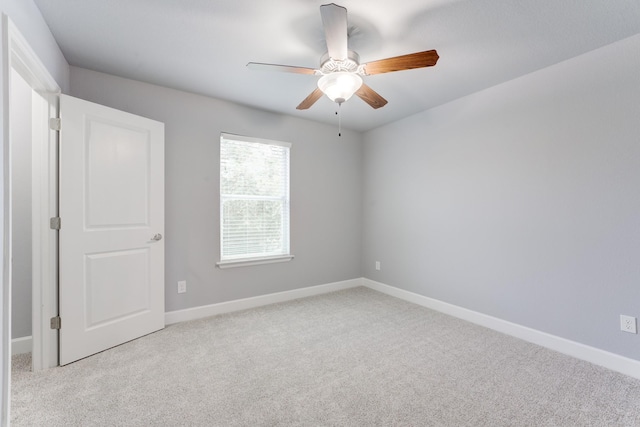 unfurnished room featuring light carpet and ceiling fan