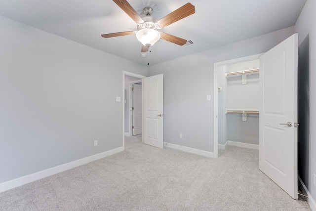 unfurnished bedroom with ceiling fan, a closet, and light carpet