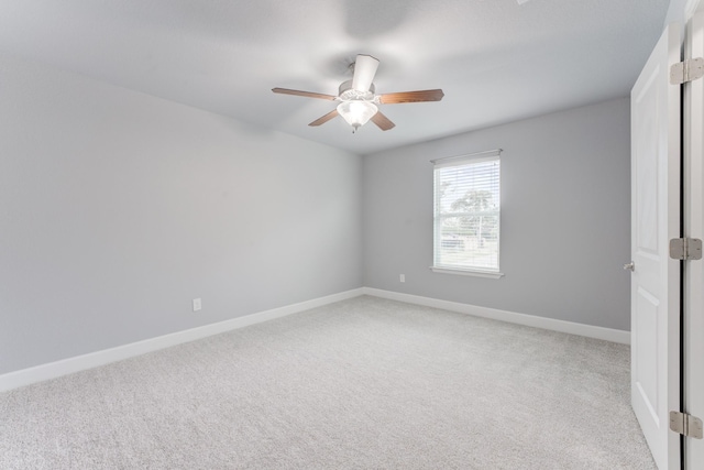 carpeted empty room featuring ceiling fan