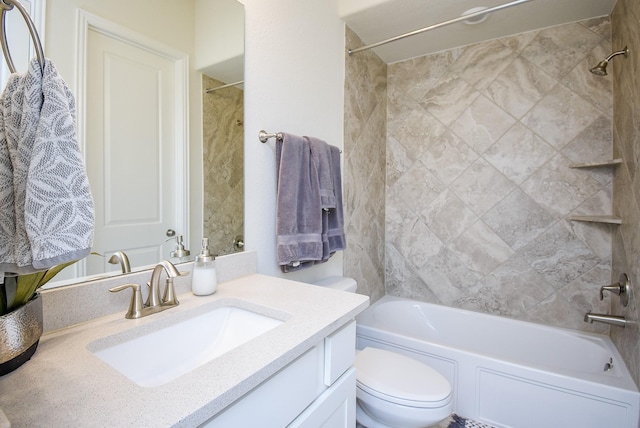 full bathroom with toilet, vanity, and tiled shower / bath