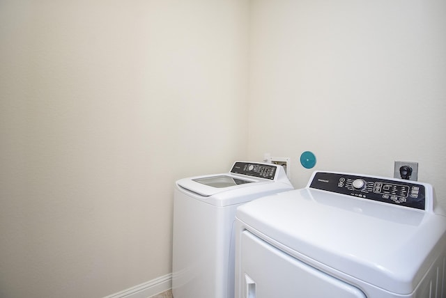 clothes washing area featuring separate washer and dryer