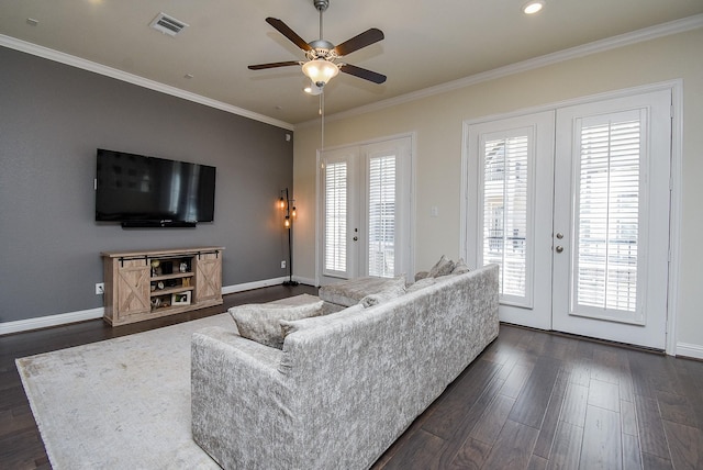 living room with ceiling fan, dark hardwood / wood-style flooring, crown molding, and french doors