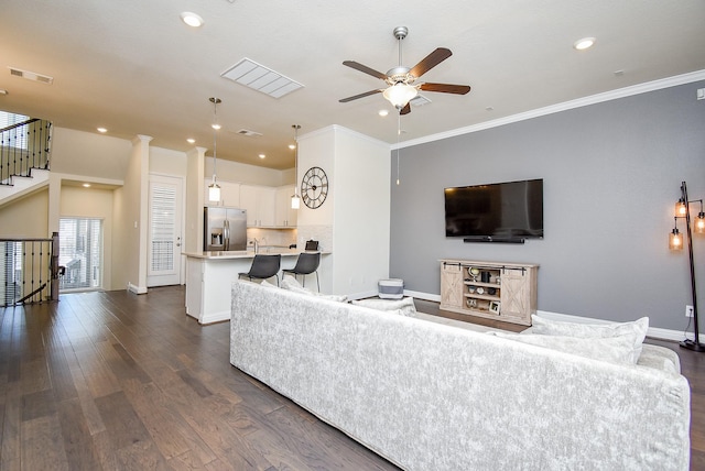 living room with ceiling fan, dark hardwood / wood-style flooring, ornamental molding, and sink