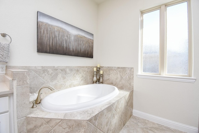 bathroom with tiled bath and vanity