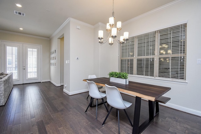 dining space with french doors, dark hardwood / wood-style flooring, crown molding, and a chandelier