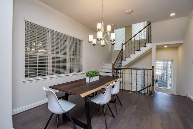 dining area with dark hardwood / wood-style floors, crown molding, and a notable chandelier