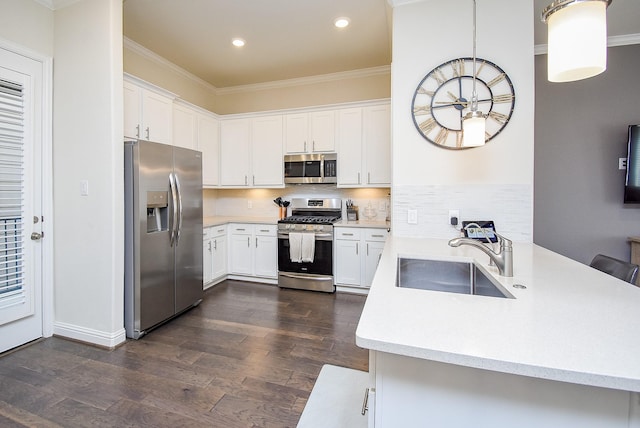 kitchen with white cabinetry, sink, hanging light fixtures, and stainless steel appliances