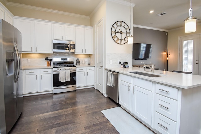 kitchen featuring decorative light fixtures, kitchen peninsula, stainless steel appliances, and white cabinetry