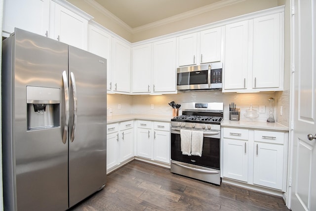 kitchen featuring decorative backsplash, stainless steel appliances, and white cabinetry