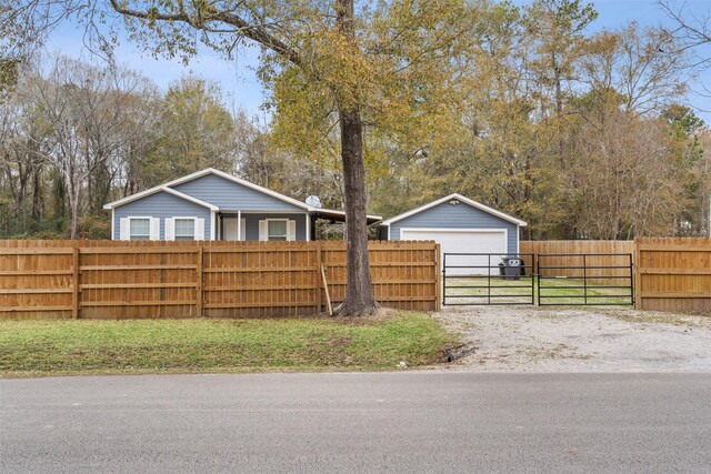 view of yard featuring a garage and an outbuilding