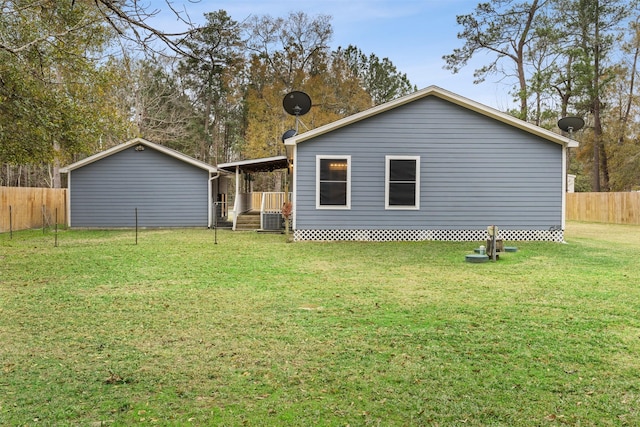 back of house with a lawn