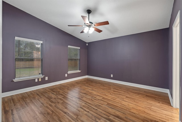 unfurnished room with ceiling fan, vaulted ceiling, and wood-type flooring