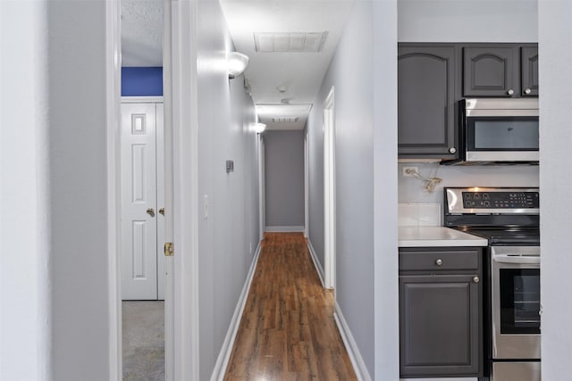 hall featuring dark hardwood / wood-style floors and a textured ceiling