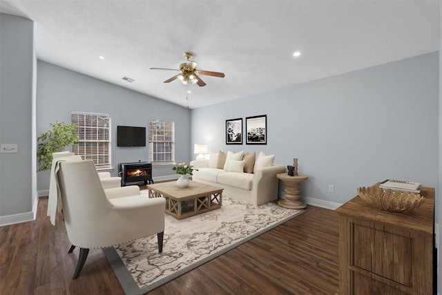 living room with ceiling fan, lofted ceiling, and dark hardwood / wood-style floors