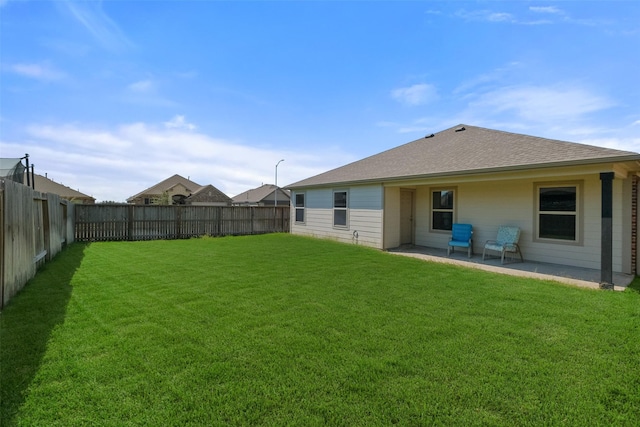 back of property with a lawn and a patio area