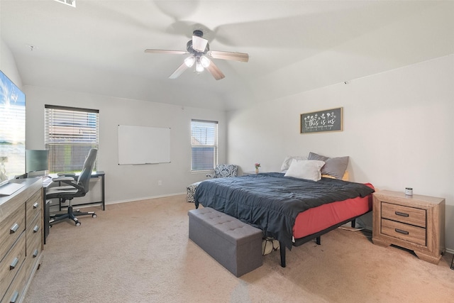 carpeted bedroom with ceiling fan and vaulted ceiling