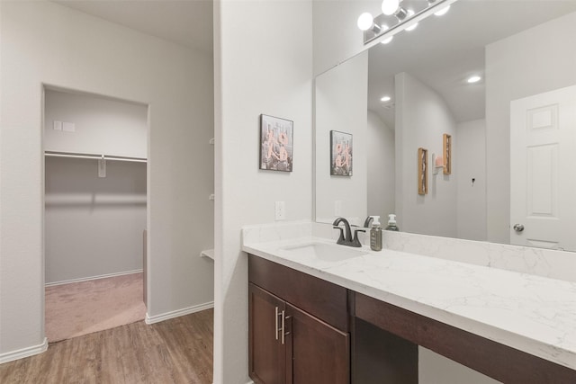 bathroom with hardwood / wood-style flooring and vanity