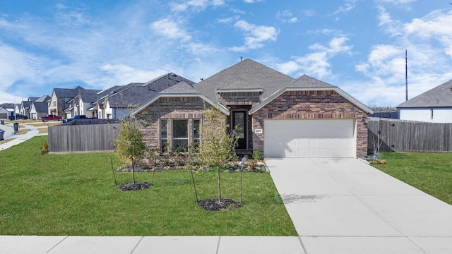 view of front of house featuring a garage, driveway, brick siding, and a front yard