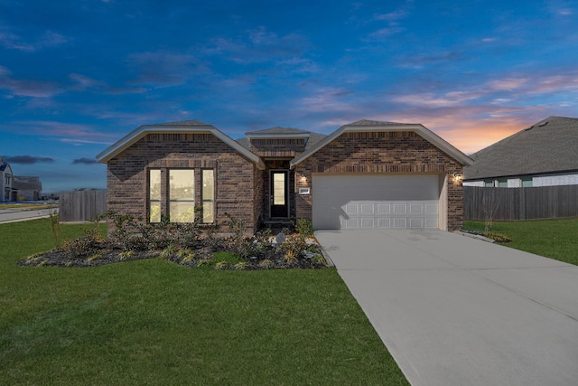 ranch-style home featuring brick siding, a yard, concrete driveway, an attached garage, and fence