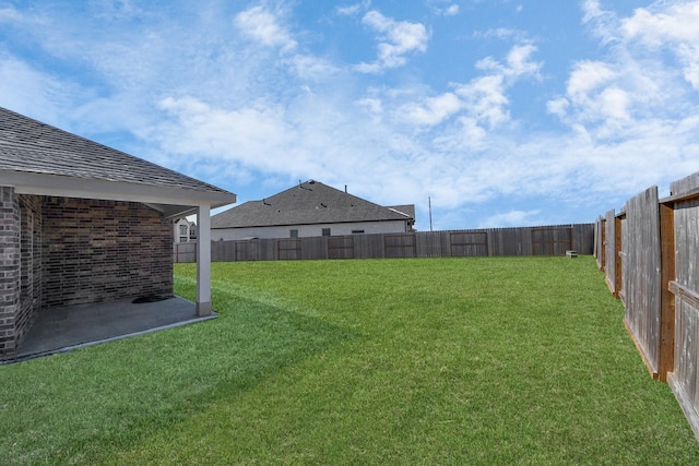 view of yard featuring a patio area and a fenced backyard