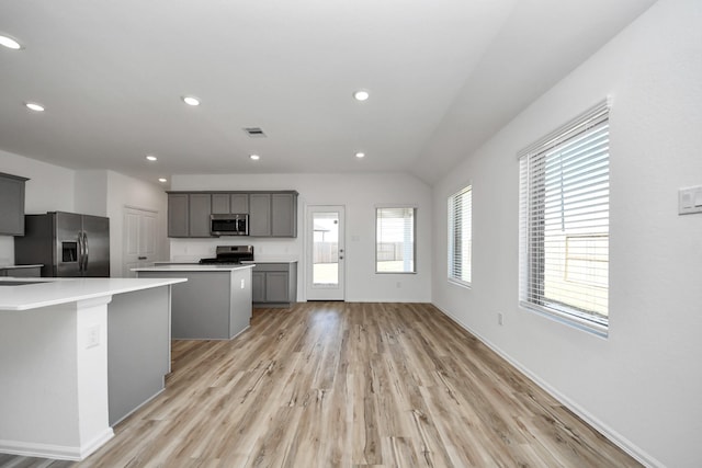 kitchen with a center island, stainless steel appliances, recessed lighting, visible vents, and gray cabinetry