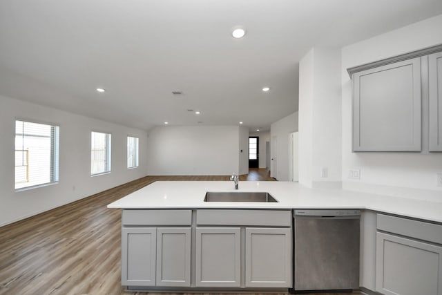 kitchen featuring gray cabinets, a sink, and stainless steel dishwasher