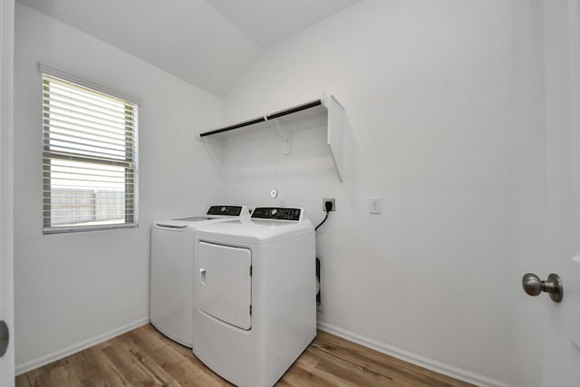 laundry room featuring laundry area, independent washer and dryer, light wood-style flooring, and baseboards