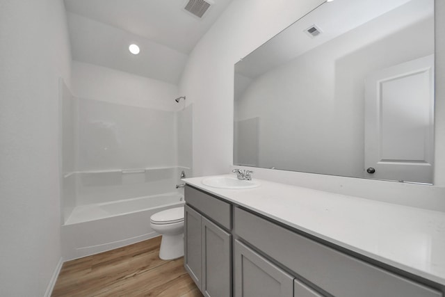 full bath with shower / bathtub combination, visible vents, toilet, vanity, and wood finished floors