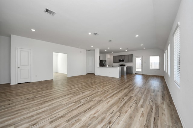 unfurnished living room with recessed lighting, visible vents, and light wood-style floors