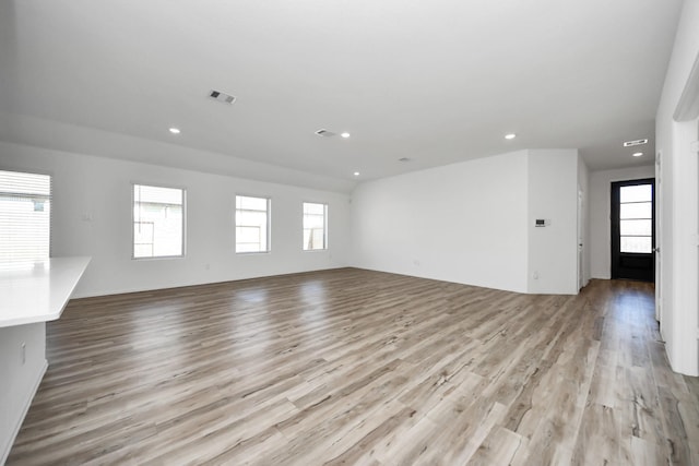 unfurnished living room featuring light wood-type flooring, visible vents, and recessed lighting