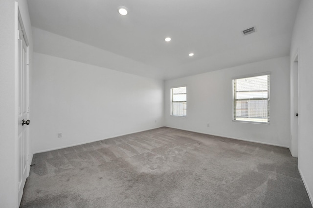 carpeted empty room with visible vents and recessed lighting