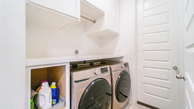 washroom featuring independent washer and dryer and cabinets