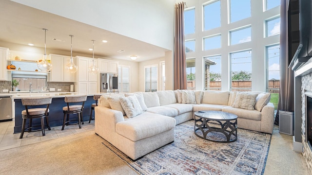 carpeted living room with a towering ceiling