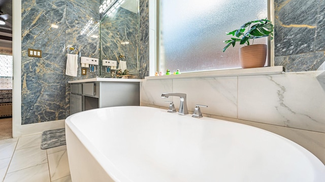 bathroom with vanity and a tub