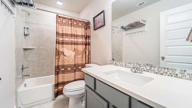 full bathroom featuring tasteful backsplash, vanity, toilet, tile patterned floors, and shower / bath combo with shower curtain